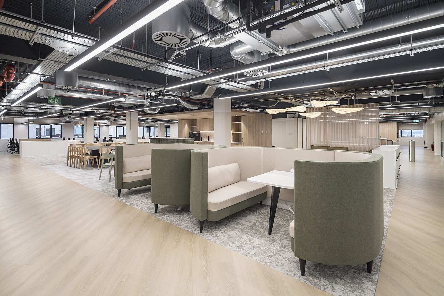 Booth seats on a wooden floor with exposed ceilings