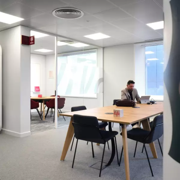 Bookable meeting rooms seamlessly intertwine with communal workspace