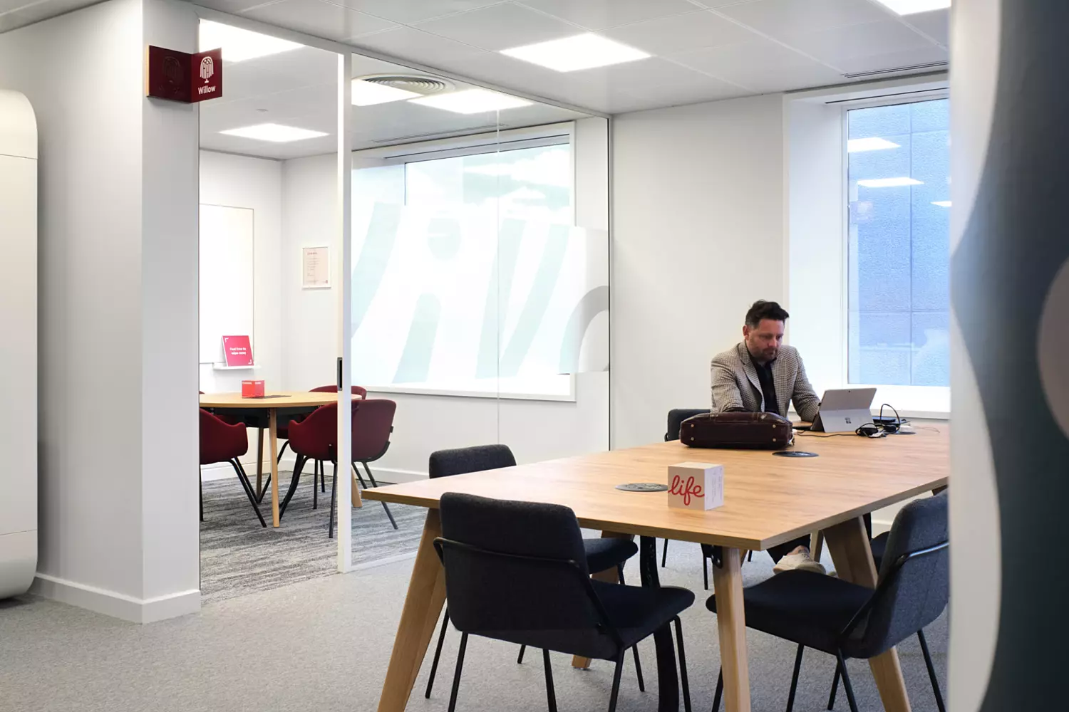 Bookable meeting rooms seamlessly intertwine with communal workspace