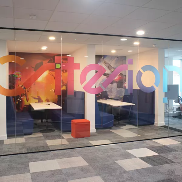 Creative branding expressed on glazed partition in office space
