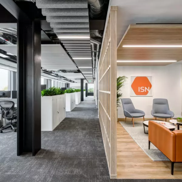 Exposed ceiling services and traditional desk space at ISN