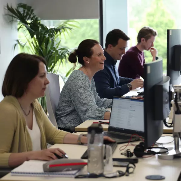 Morgan Lovell people laughing in traditional office space