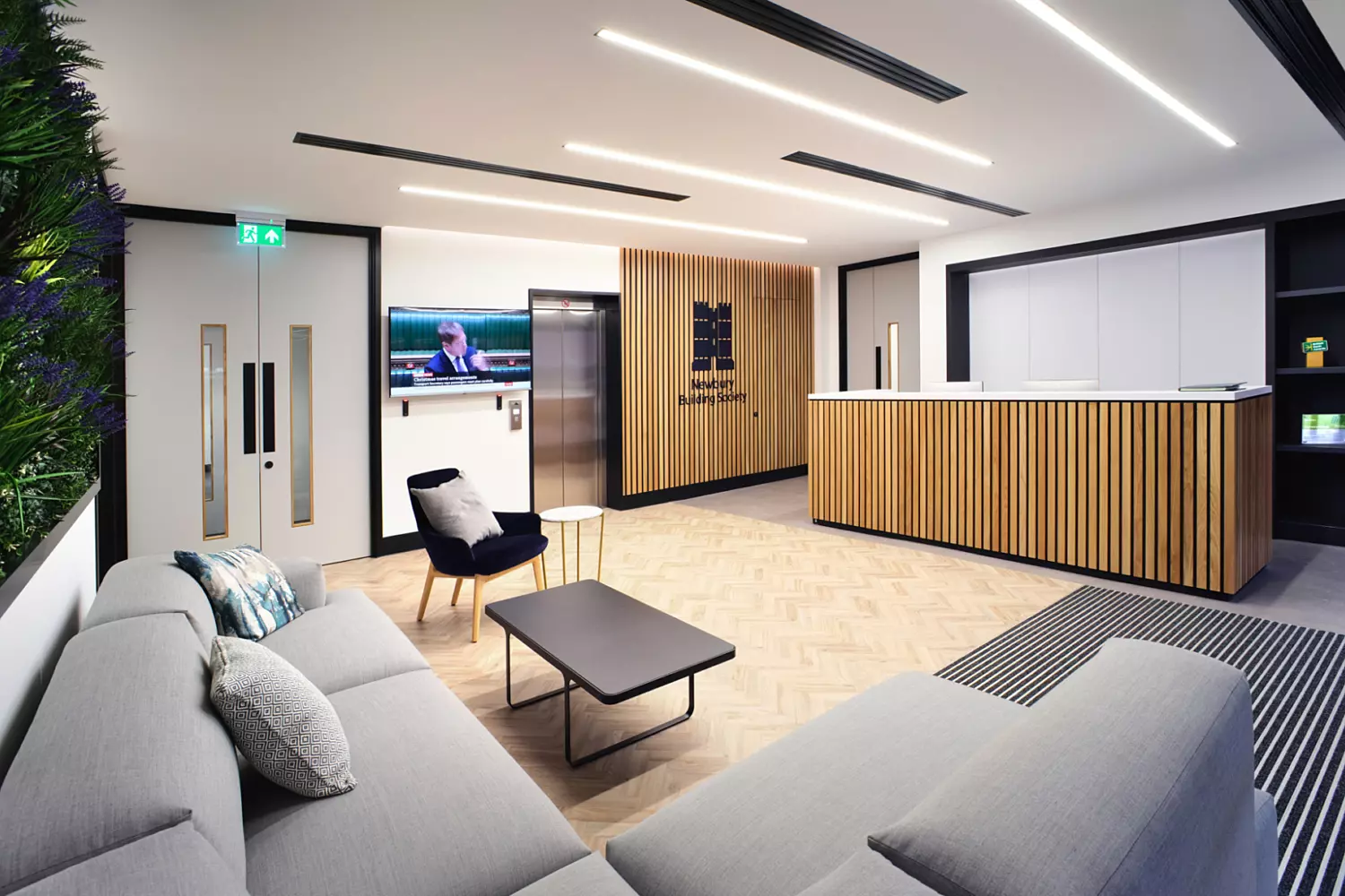 Newbury Building Societies reception features timber beading and soft furnishings