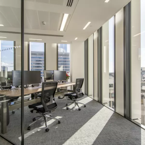 Natural light floods touchdown desk areas