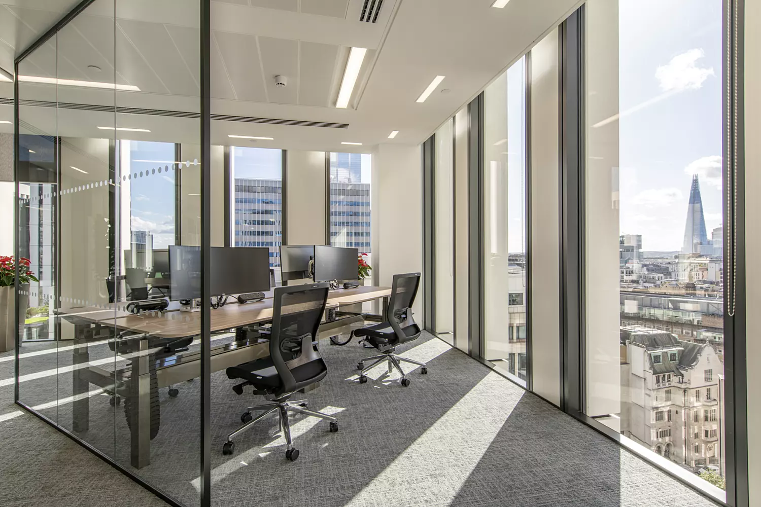 Natural light floods touchdown desk areas