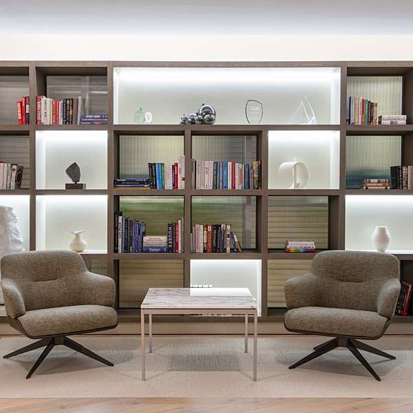 Bookcase with seating and ornaments in workplace fit out