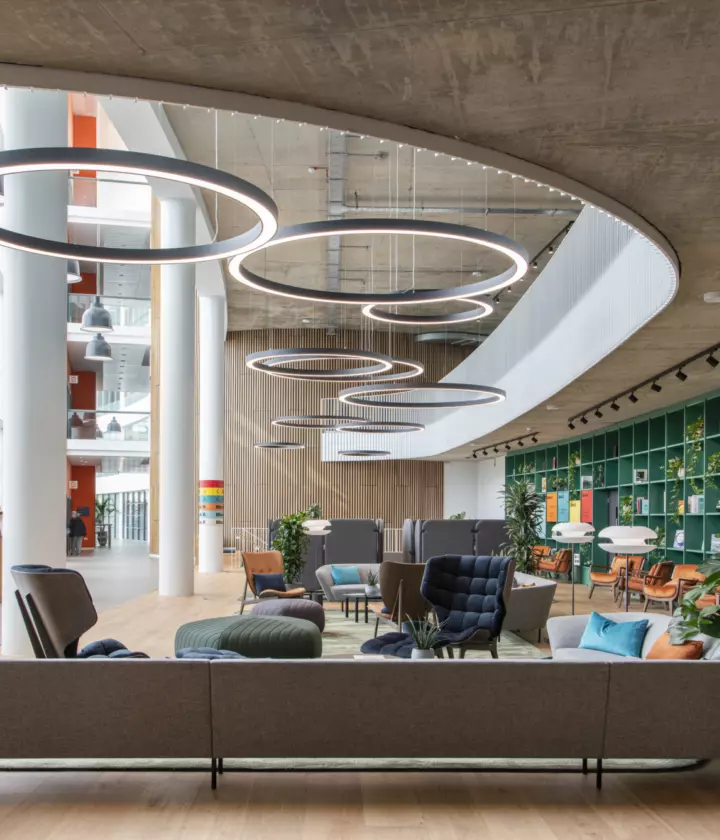 Natural light is complimented but atmospheric LED ring lights in a double height atrium