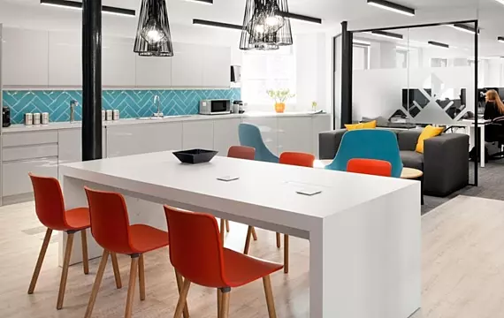 Modern office kitchen and lounge area with stylish seating