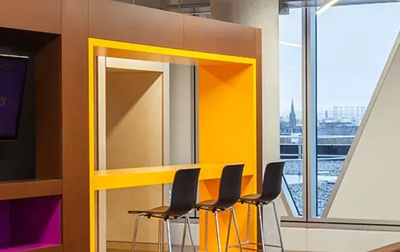 Trendy office fit out with vibrant breakout space and sleek seating area.