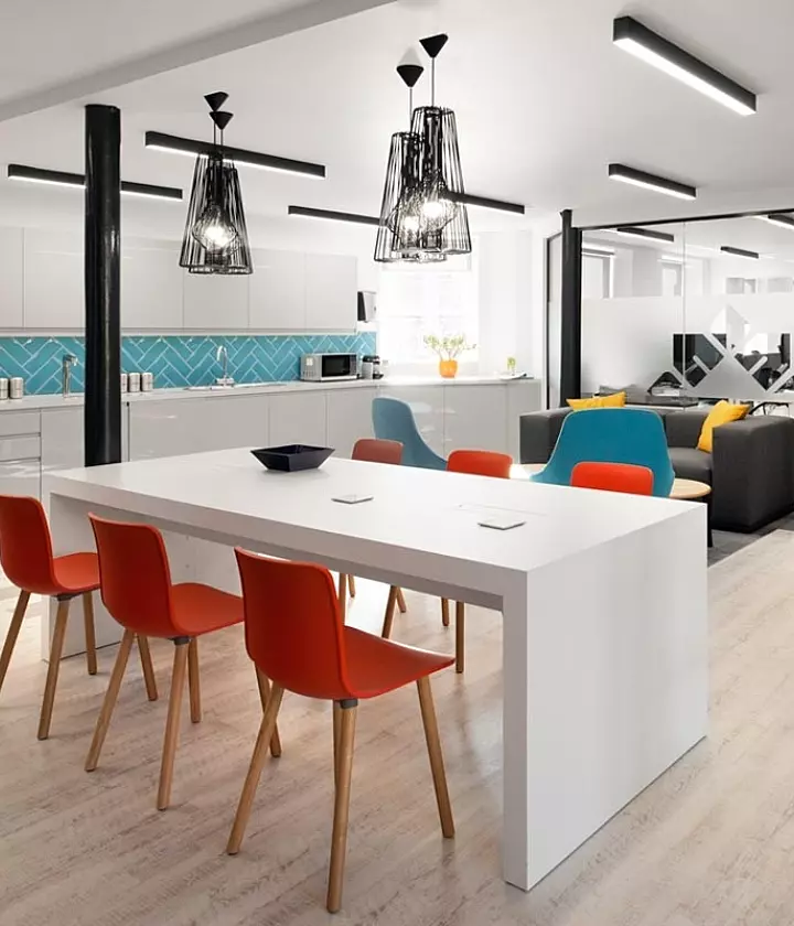 Modern office kitchen and lounge area with stylish seating
