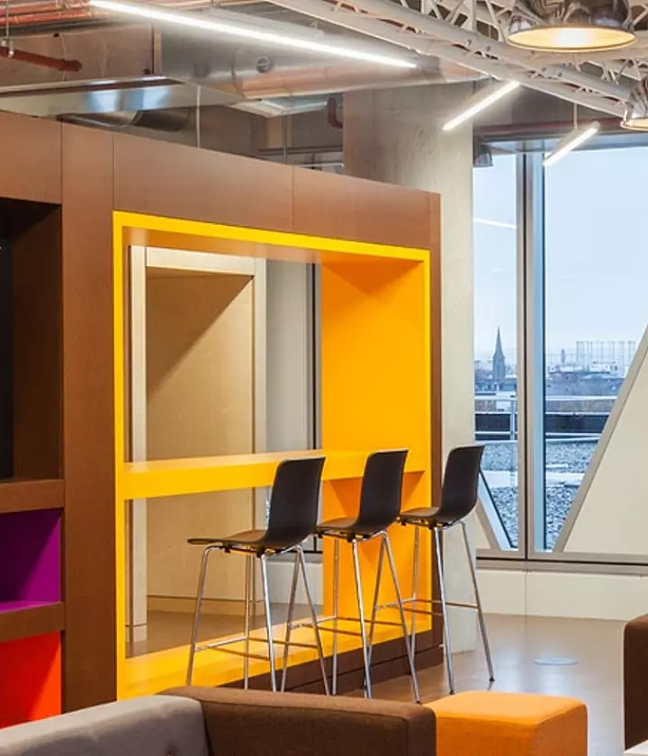 Trendy office fit out with vibrant breakout space and sleek seating area.