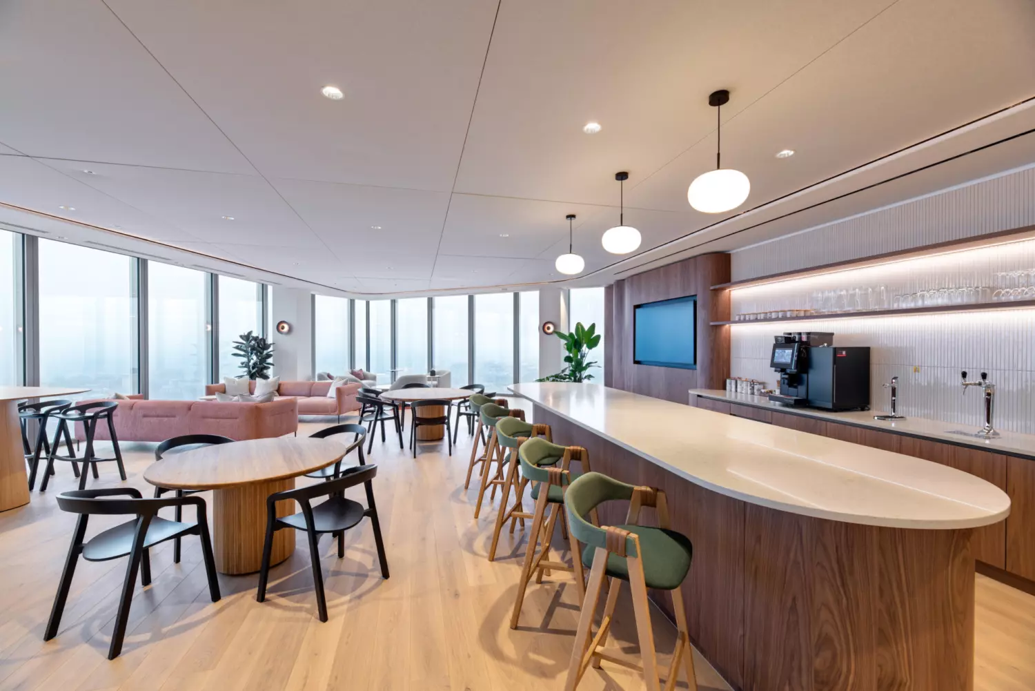 Contemporary office interior with custom branding, breakout seating, and high end finishes designed for employee wellbeing.