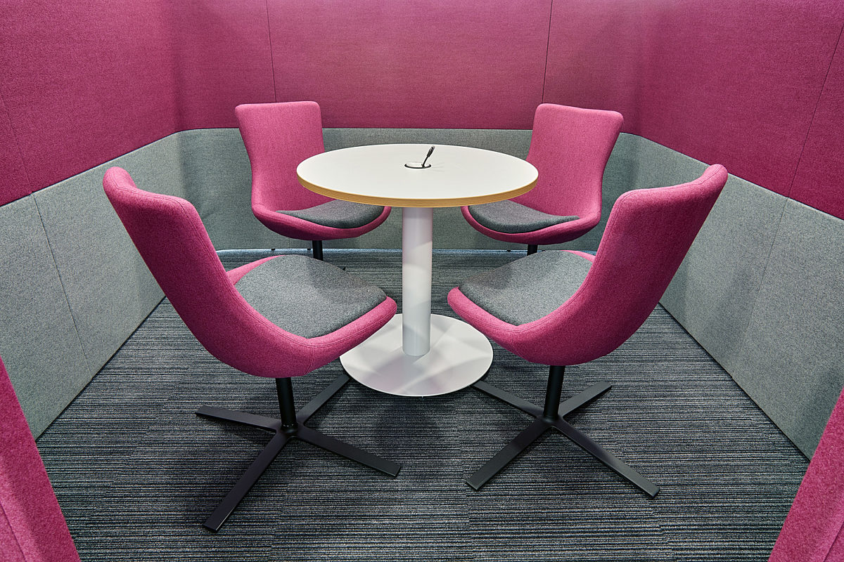 Pink office furniture in breakout area