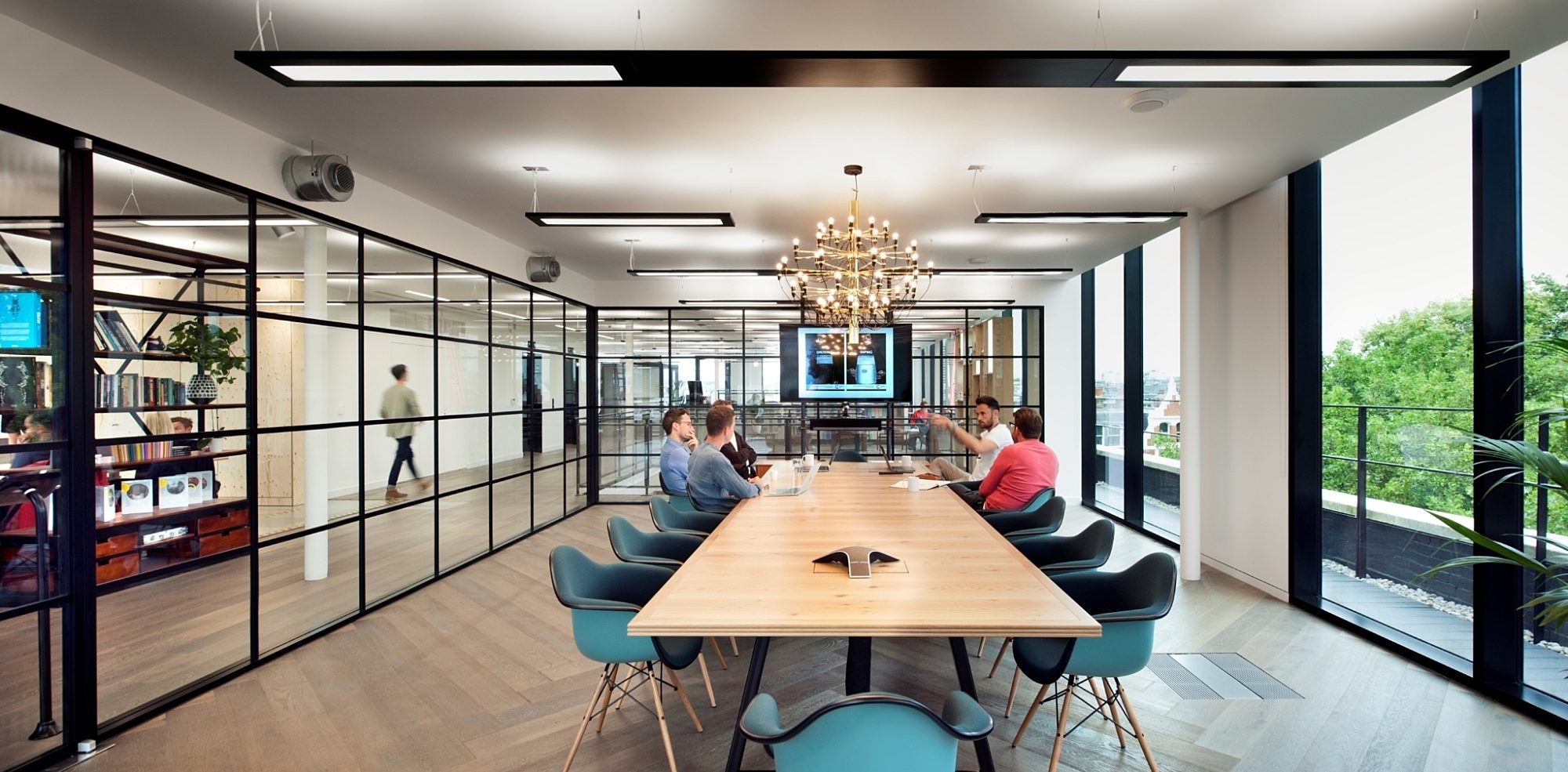 Office boardroom table with natural light and chandelier