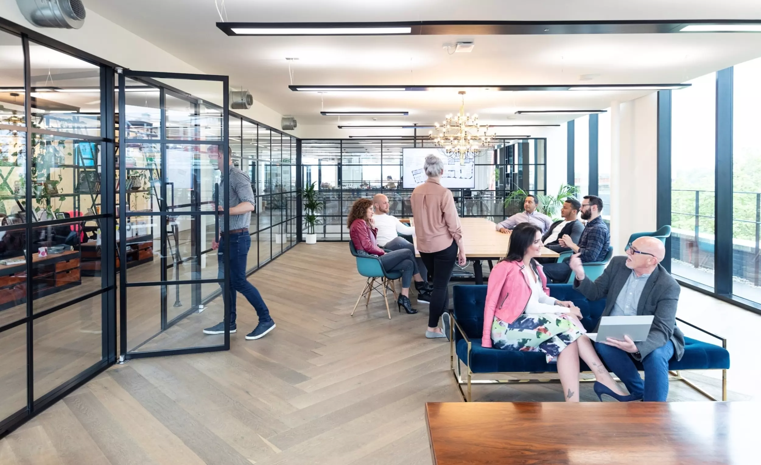 People collaborating in Anomaly's co-working inspired office design