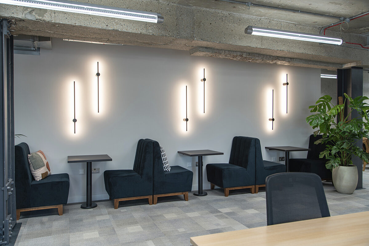 One to one booths are complemented by wall mounted beam lighting