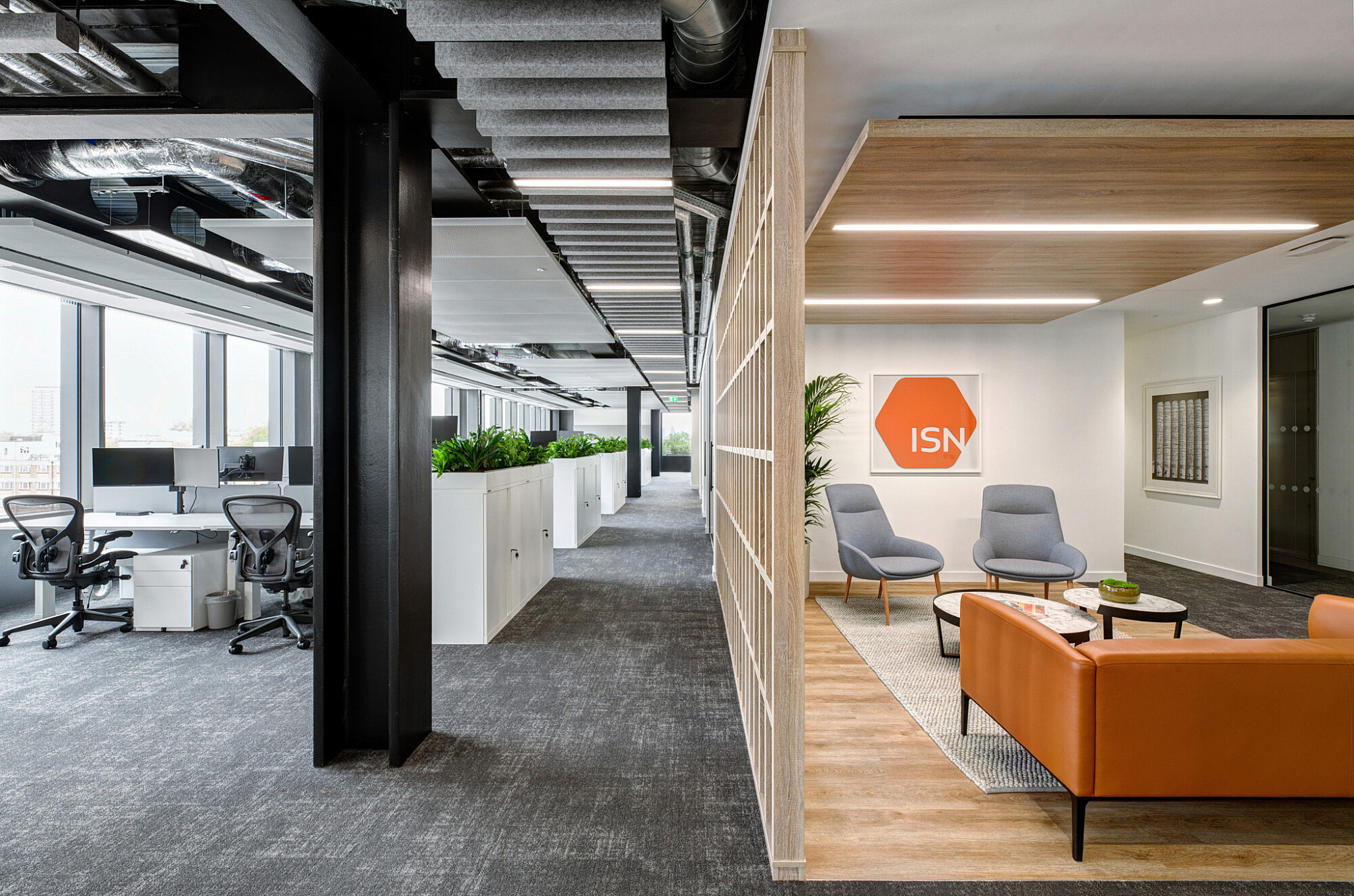 Exposed ceiling services and traditional desk space at ISN