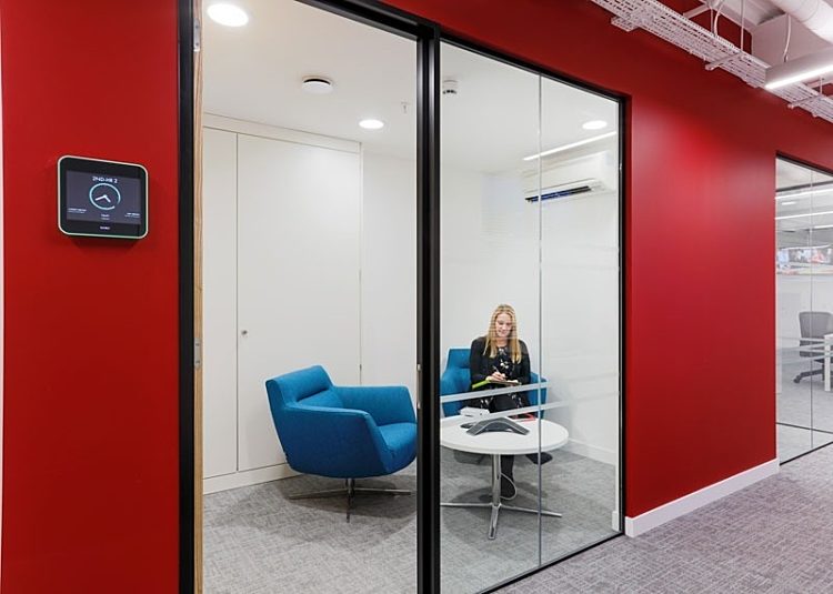 Woman using smart meeting room technology