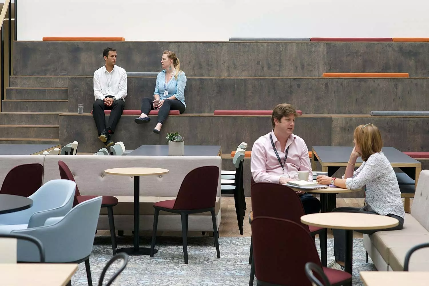 A collaborative breakout space with tiered seating and casual meeting areas.