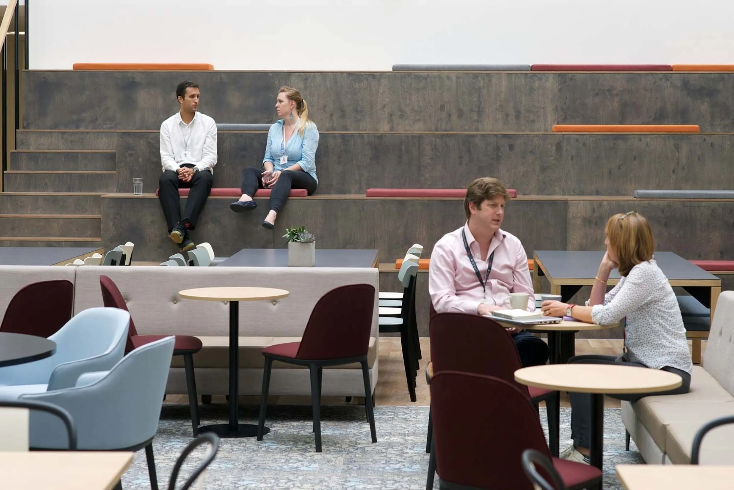 A collaborative breakout space with tiered seating and casual meeting areas.